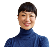 A close-up portrait of a business professional in a blue turtleneck
